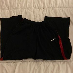 Black w/ red stripe Nike sweats, boys med. grips condition